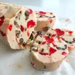 Christmas maraschino cherry shortbread cookies broken apart to show tender crumbly texture with red cherries and chocolate