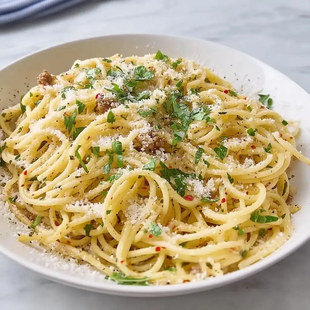 Sizzling spaghetti with ground beef, fresh herbs, and grated Parmesan cheese in white bowl