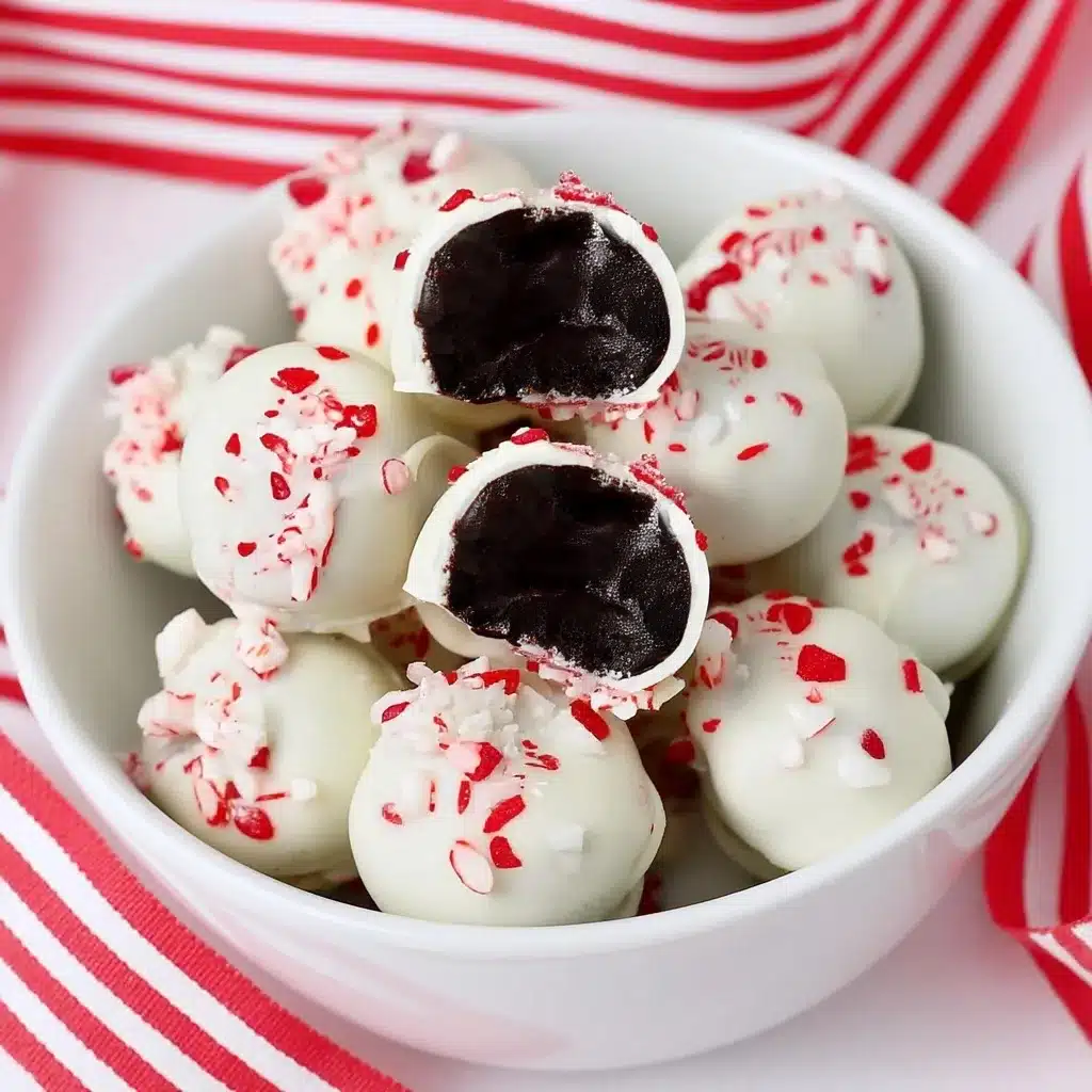 Cross-section revealing dark Oreo filling inside a white chocolate peppermint truffle