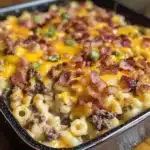 Easy Loaded Bacon Cheeseburger Dinner Casserole with melted cheddar cheese, crispy bacon pieces, and elbow macaroni in black baking dish