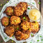 Classic potato latkes recipe showing crispy fried potato pancakes with fresh herbs on rustic serving plate