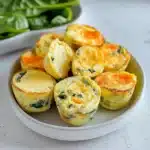Multiple cottage cheese egg bites on round plate showing different angles and cross-sections
