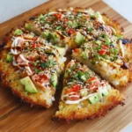 Sushi pizza crust recipe result showing golden crispy base topped with salmon, avocado and traditional Japanese sauces