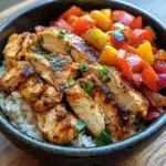 Chicken Fajita Rice Bowl with seasoned chicken strips, colorful bell peppers, and fresh cilantro on white rice