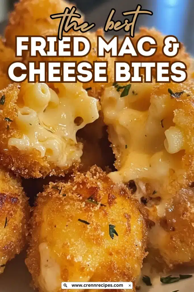 Extreme close-up of a broken fried mac and cheese bite showing the golden crispy exterior and gooey macaroni and cheese filling stretching inside.