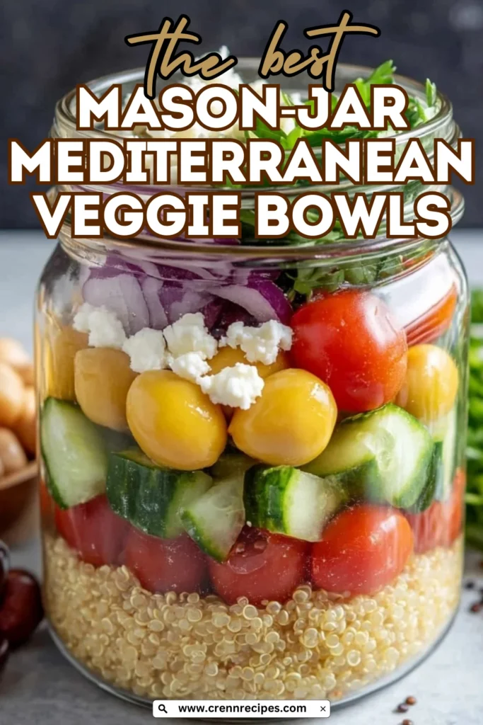 Close-up of a Mason-Jar Mediterranean Veggie Bowl showing detailed layers of quinoa, tomatoes, cucumber, chickpeas, feta cheese, red onion, and fresh herbs with Mediterranean ingredients in the background.
