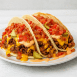 Loaded bacon cheeseburger tacos with seasoned beef melted cheese fresh toppings