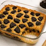Oreo Dump Cake recipe in baking dish with golden top and Oreo chunks - CrennRecipes.com