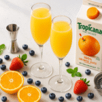 Perfect mimosa recipe with champagne flutes, Dom Pérignon, fresh orange juice, and premium brunch cocktail ingredients