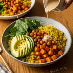 Signature turmeric chickpea power bowl served in premium Anthropologie dinnerware with healing golden ingredients
