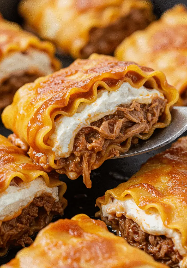 Bourbon BBQ pulled pork lasagna rolls with crispy cheese topping and smoky barbecue glaze